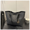 Black PU shoulder bag with sewing thread detail, showing interior polyester lining.