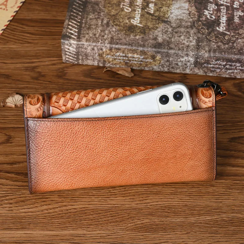 Retro brown Chinese floral embossed tri-fold women's leather wallet open to show compartments.