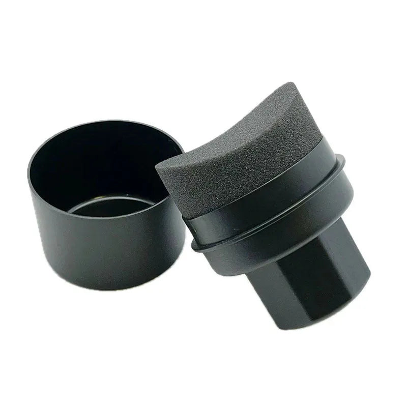 Black and red tyre oil sponge brushes with lids on a white background.