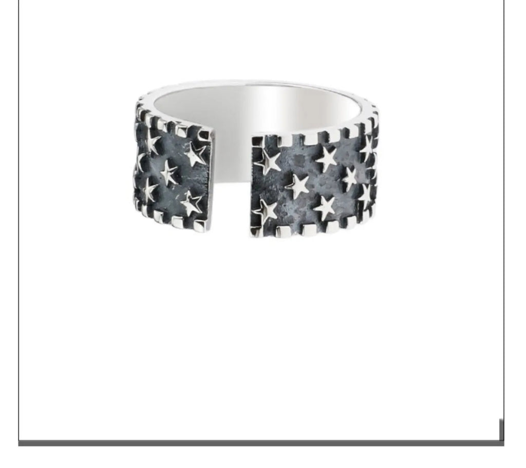 Adjustable opening sterling silver ring with a multi five-pointed star geometric pattern.
