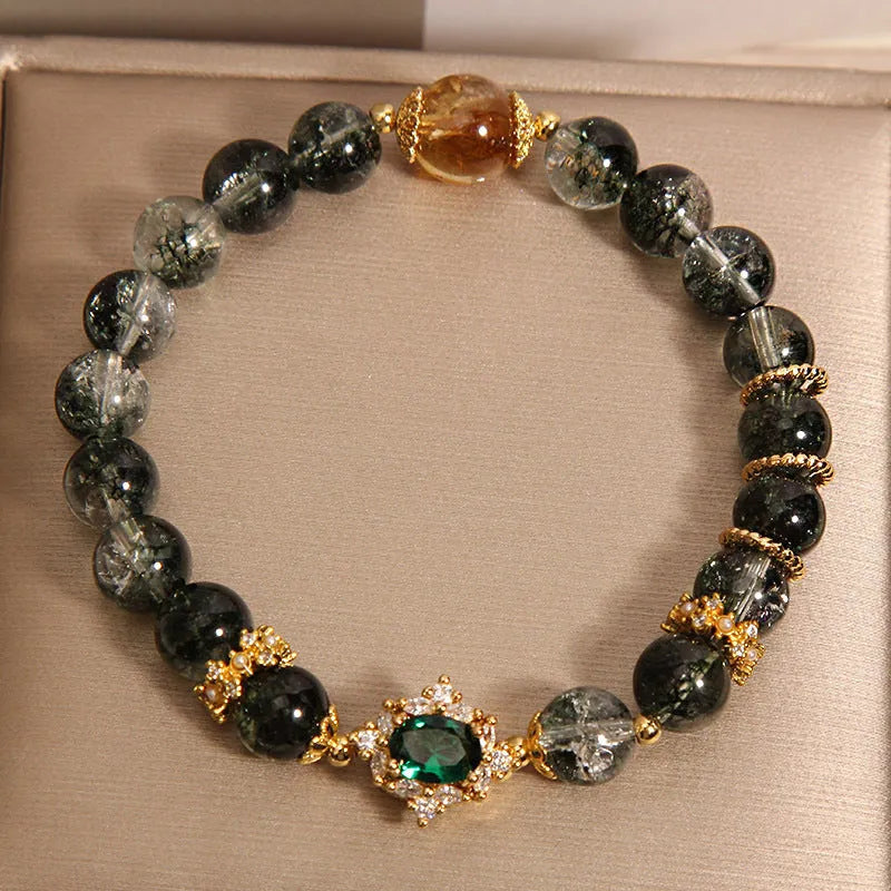 Women's crystal bracelet with gold rutilated quartz, green phantom quartz, and ruby quartz gemstones