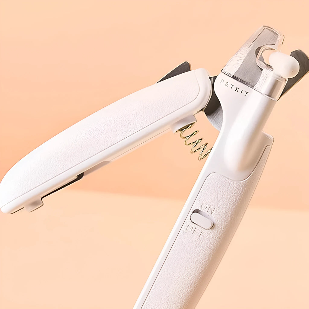 White pet nail clippers with LED light, transparent guard, and built-in file for cats and dogs.