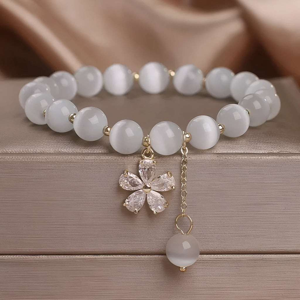 Women's white cat's eye stone bracelet with morganite pendant and flower tassel on safety buckle clasp
