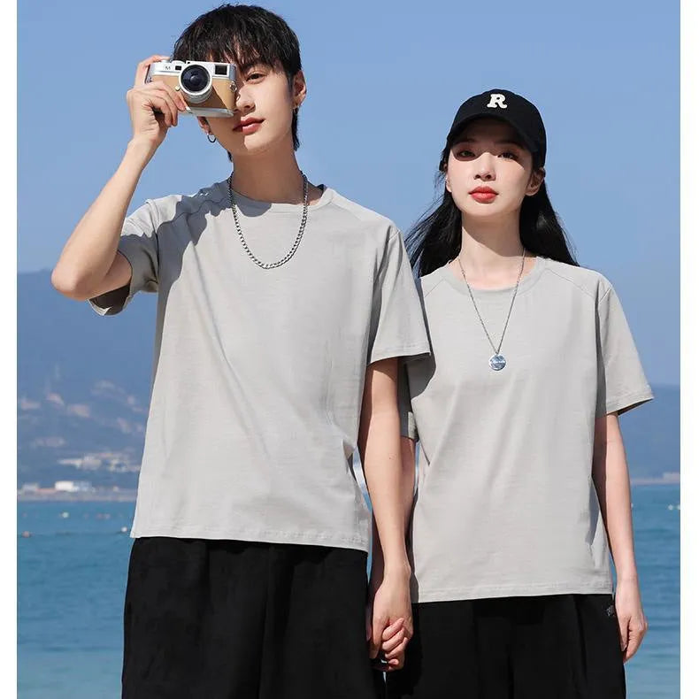 Men's solid colour cotton short sleeve t-shirt laid flat, showing colour options including black, white, and bright orange.