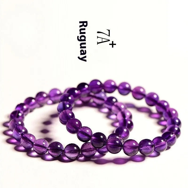 Natural amethyst scattered beads Uruguay bracelet in polished crystal on a white background.