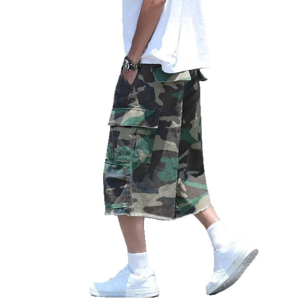 Man wearing loose fit camouflage retro workwear shorts in a khaki camouflage pattern.