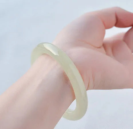 Round bar jade bracelet showing smooth geometric shape and cool stone finish.