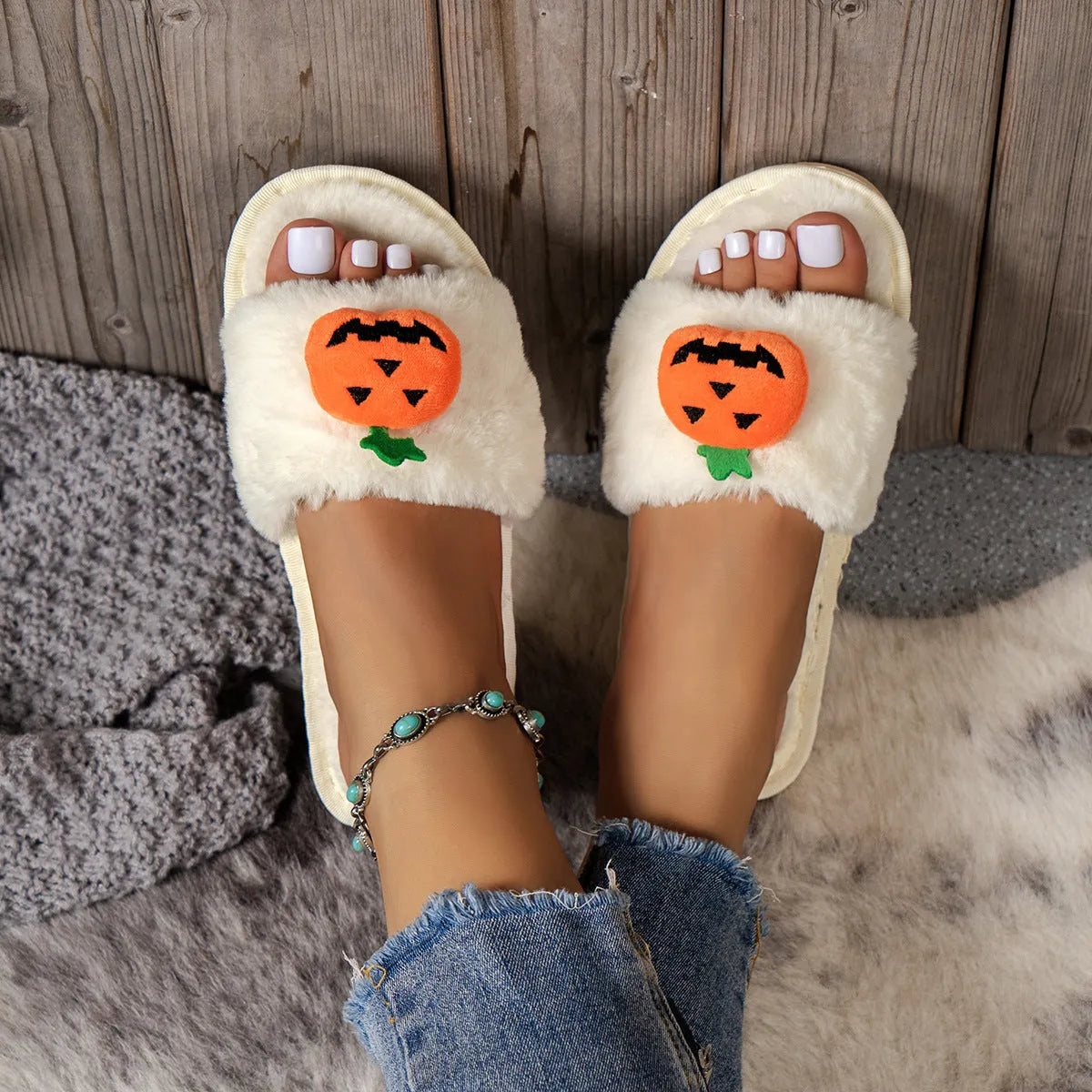 Pumpkin-themed plush slippers with open toe design and anti-slip PVC soles in white and yellow colour options