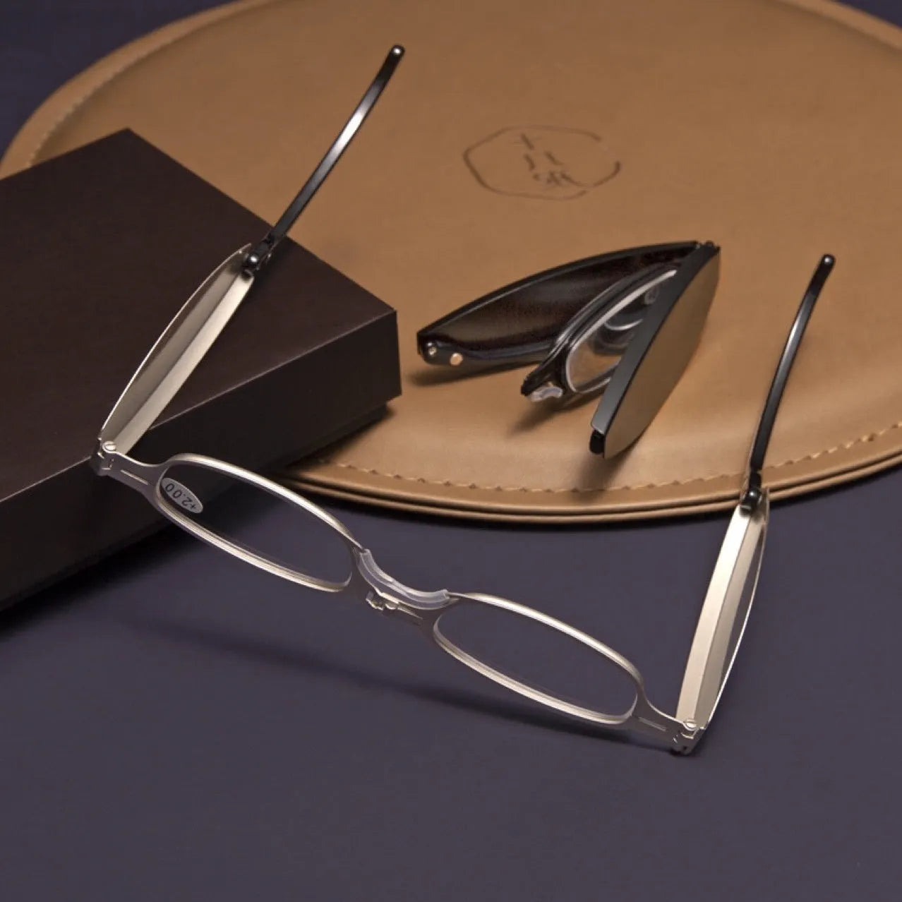 Man's folding pocket presbyopic glasses with retro ring frame in black, shown open and folded.