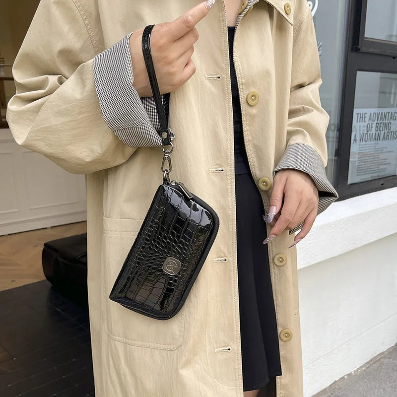 Hand-held rectangular PU mobile phone bag with crystal bamboo pattern in black, shown open to reveal inner pockets.