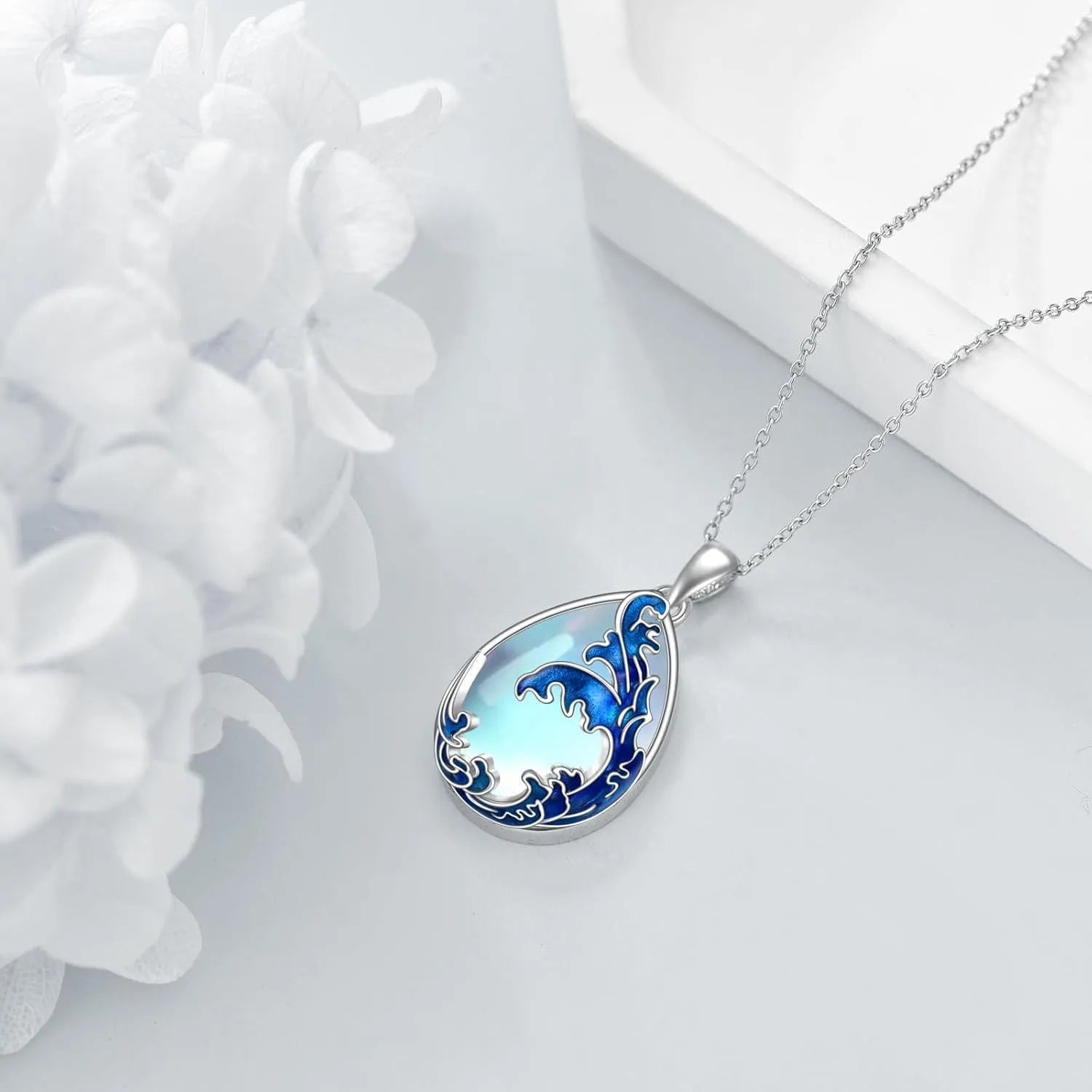 Moonstone blue heart-shaped alloy pendant on a women's necklace.