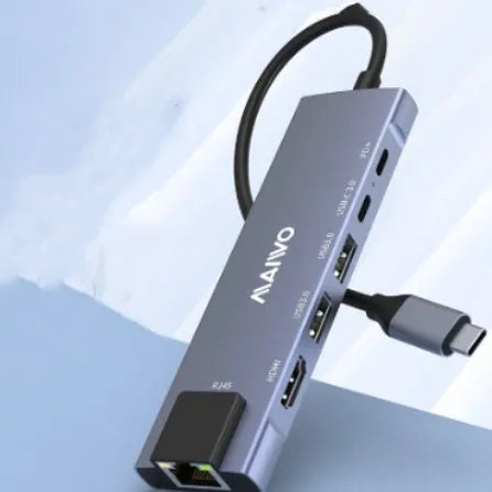 Steam Deck six-in-one USB-C docking station with aluminium shell, showing HDMI, USB 3.0, and RJ45 Ethernet ports.