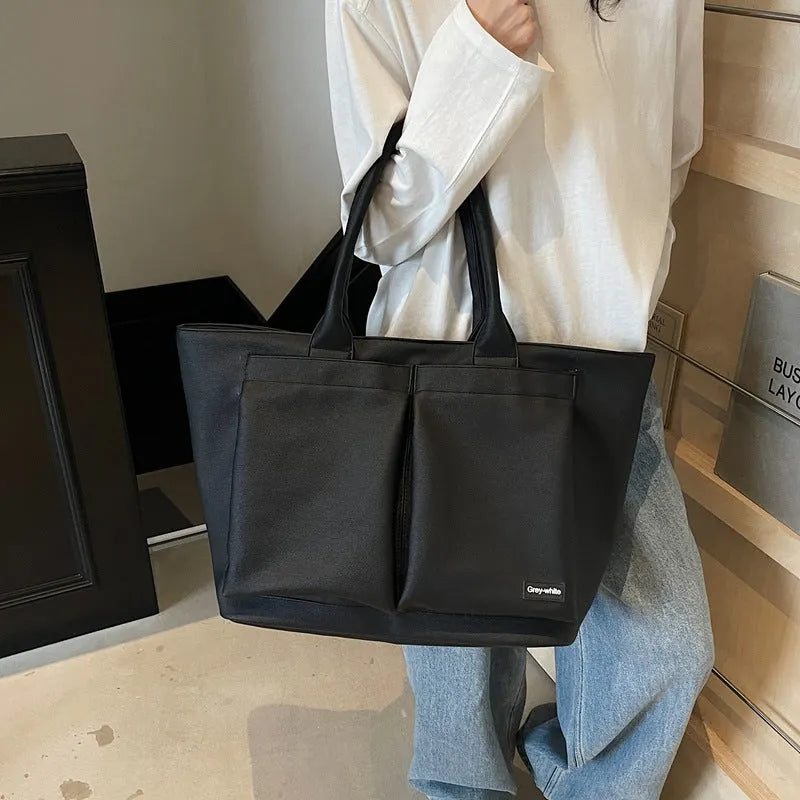 Lightweight PU shoulder bag in solid colour with ventilation features and 20-35L capacity