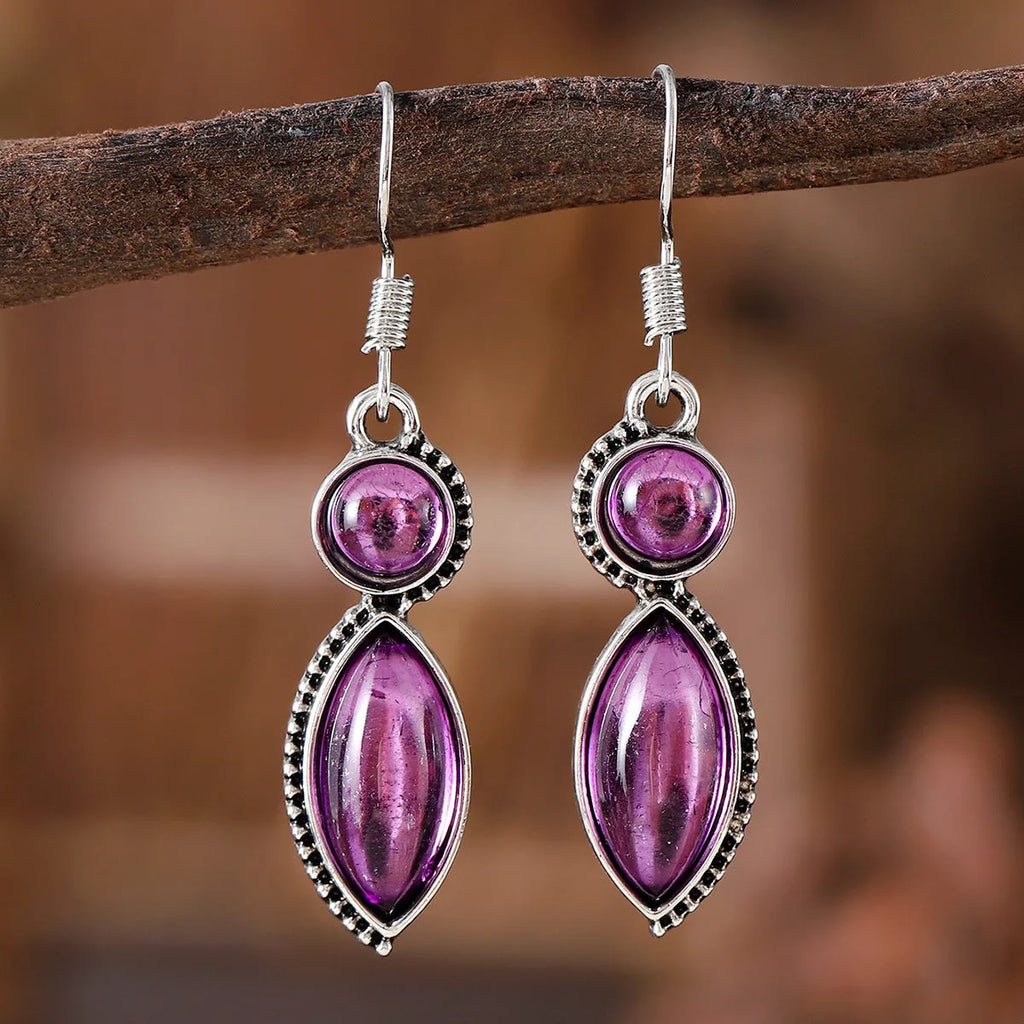 A pair of vintage-style geometric earrings with a black and purple electroplated finish on a zinc alloy base.