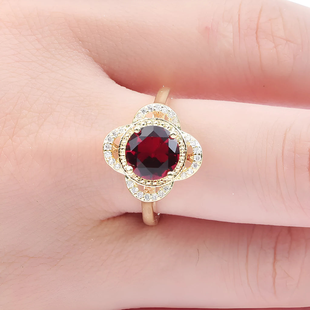 Copper fruit-shaped ring with a central zircon inlay on a model's finger.