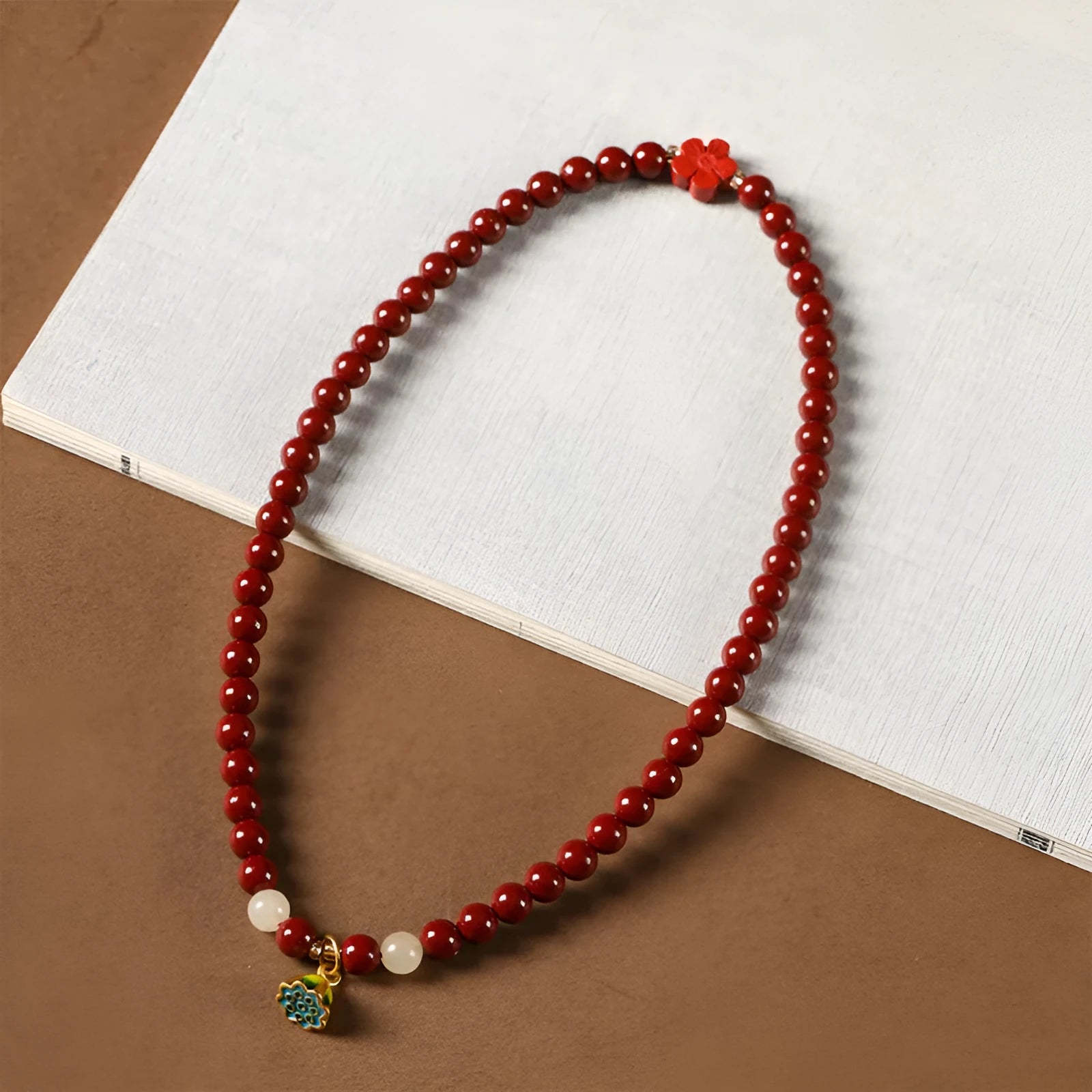 Close-up of a hand-woven double circle bracelet made with purple gold sand beads and a lotus seedpod charm.