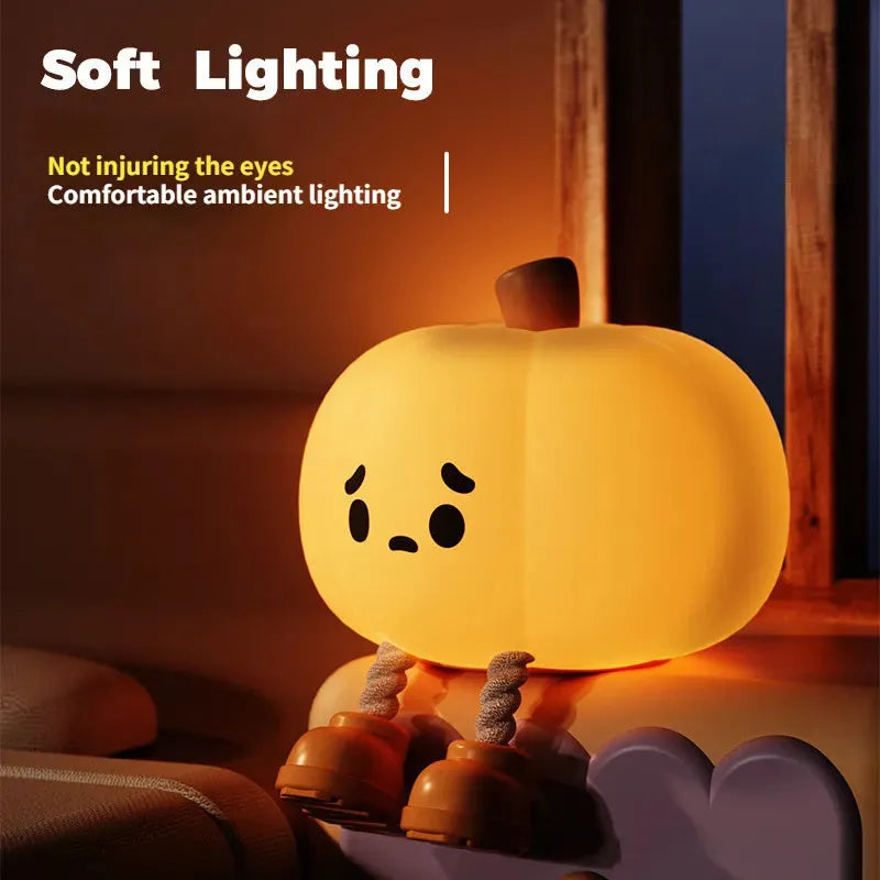 Orange pumpkin-shaped silicone night light with soft glowing illumination