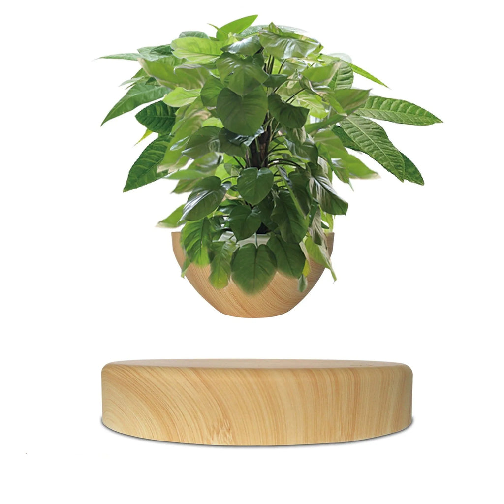 Maglev potted desktop ornament with wood grain finish floating a small artificial plant above a black base