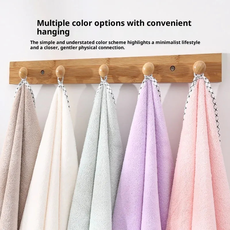 Three-piece coral fleece towel set in vanilla colour with one bath towel and two hand towels on a white background
