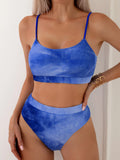 Women's blue and orange tie-dye pleated split bikini on a size chart
