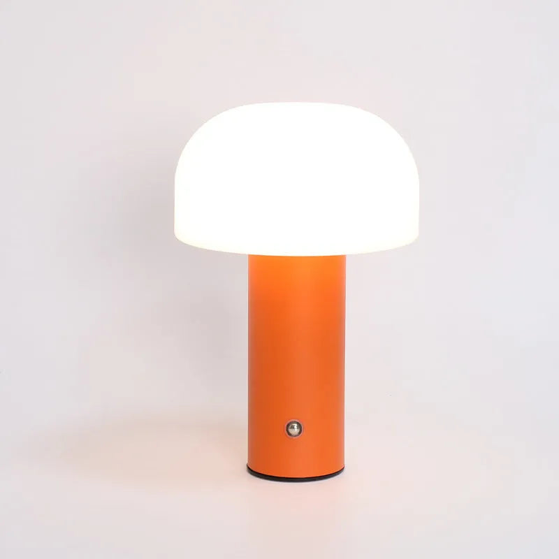 USB-powered table lamp in choice of black, white, orange or green, featuring a built-in charging port