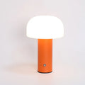 USB-powered table lamp in choice of black, white, orange or green, featuring a built-in charging port