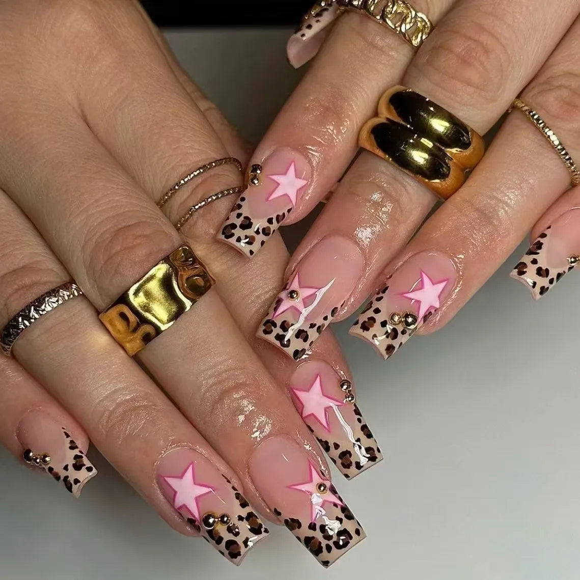 French manicure nail art set with leopard print patterns, five-pointed stars, pearls and diamond decorations