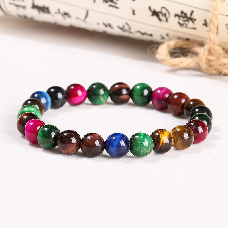 Colourful Tigereye stone bracelet with round beads on a mixed string, showing natural stone variations.