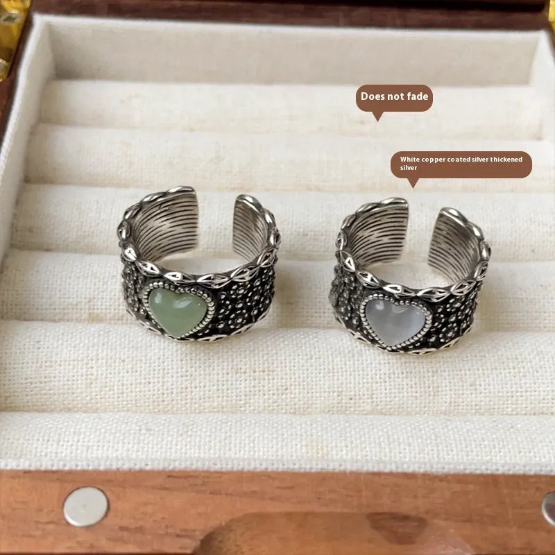Retro wide-faced silver heart ring with adjustable opening on a white background.