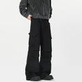 Men's black high-waisted straight-leg trousers with a button fly front, laid flat on a grey background.