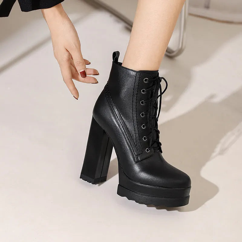 Women's black waterproof platform high heel boots with a chunky block heel and side zip.