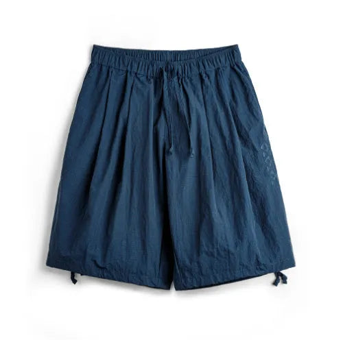 Men's loose fit nylon shorts in Prussian Blue with embroidered detailing