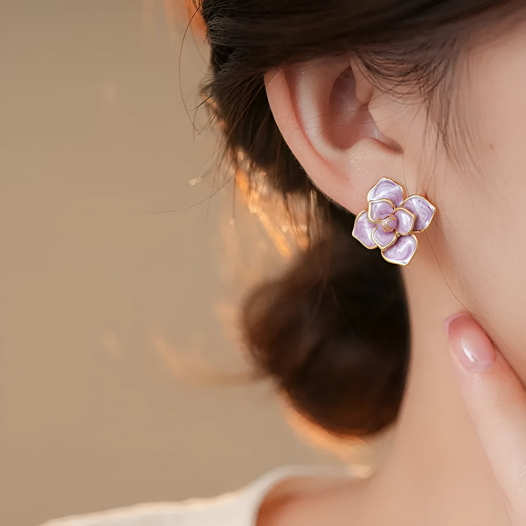 Gold plated purple flower stud earrings with copper base and fresh floral style on silver needle