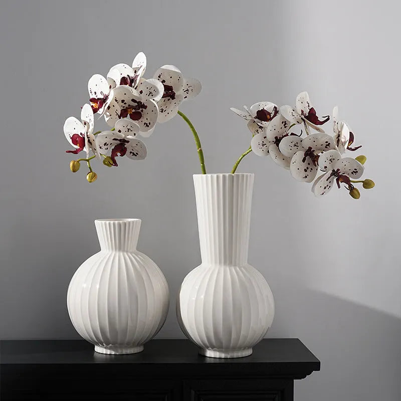 White ceramic vase with blue stripes in ball shape on wooden table