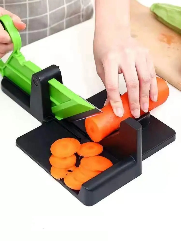Green vegetable cutter with stainless steel blades for carrot and potato slicing in kitchen