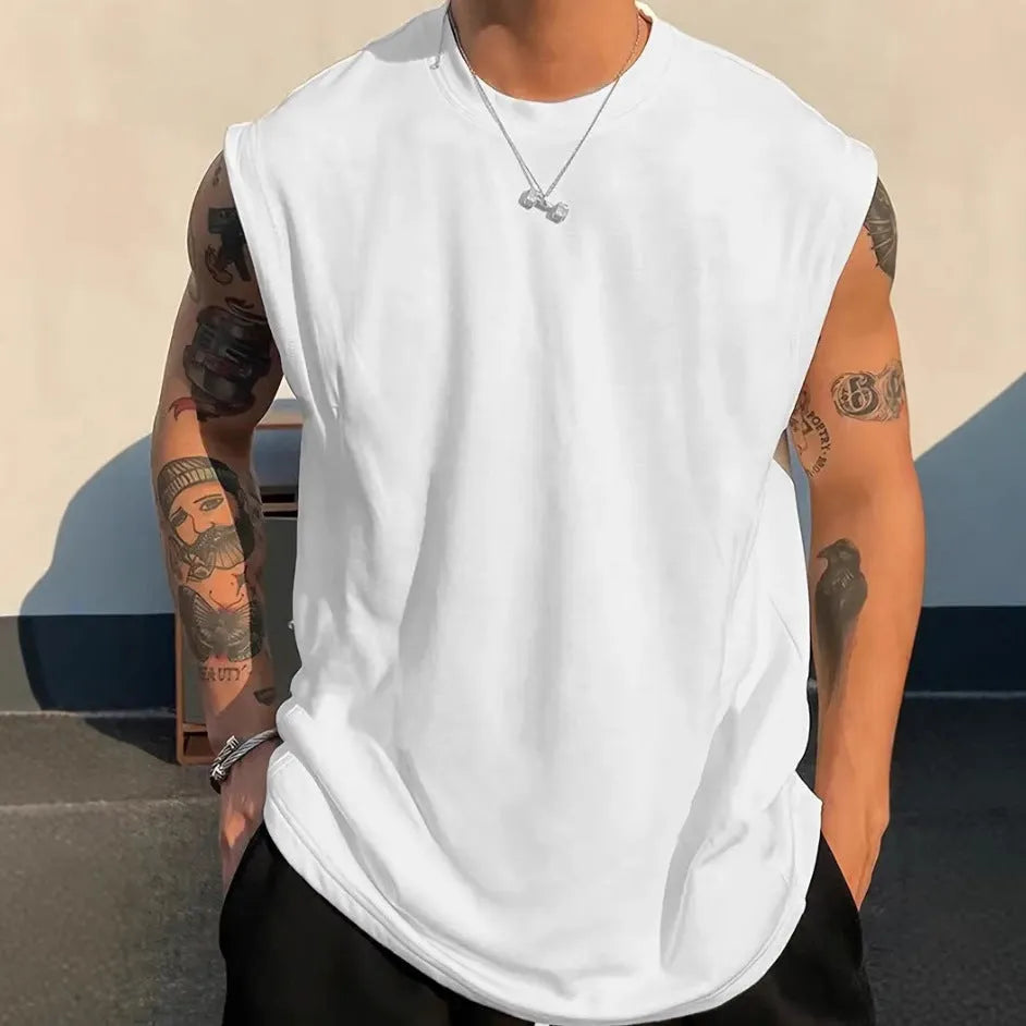 Men's loose apricot-coloured cotton tank top on a hanger.