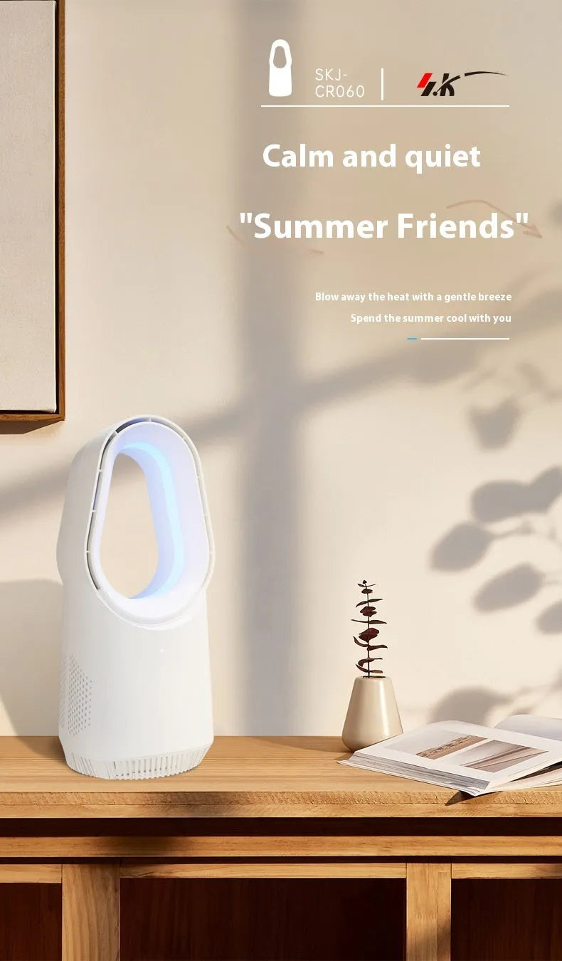 White bladeless tower fan with remote control placed on a desk next to a laptop.