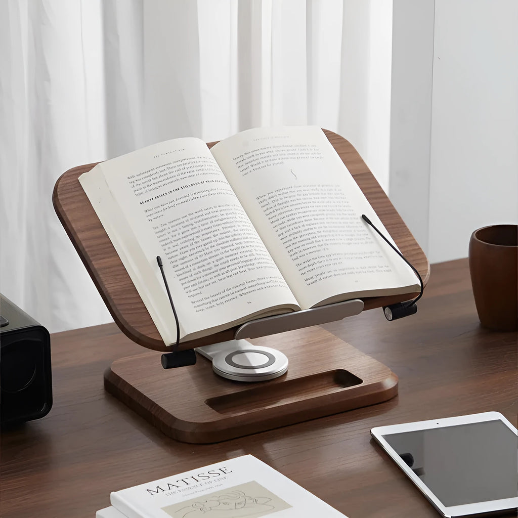 Solid wood adjustable reading rack in walnut colour holding a book on a table.