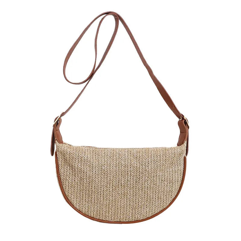 Women's woven straw crossbody bag showing textured surface with phone and file compartments inside