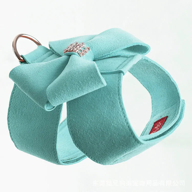 Pink adjustable dog chest strap with a cute bowknot detail, shown on a small puppy.