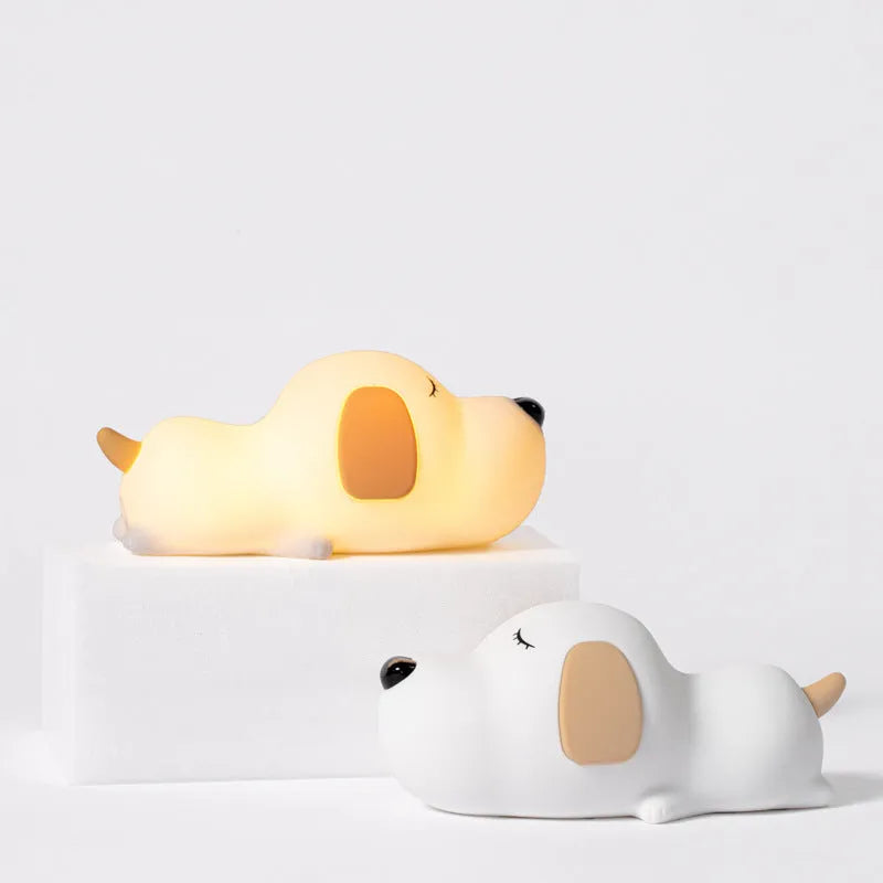 Cute two-colour silicone cartoon dog USB rechargeable night lamp on a surface.