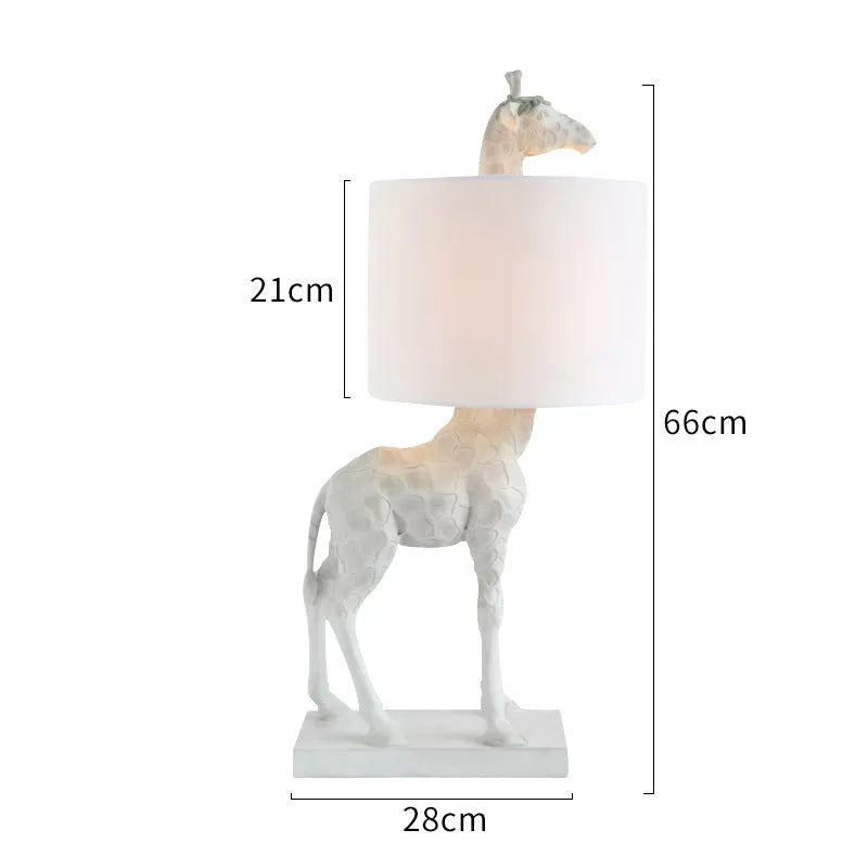 White or gold giraffe table lamp measuring 66cm tall with resin and cloth construction