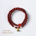 Close-up of a hand-woven double circle bracelet made with purple gold sand beads and a lotus seedpod charm.