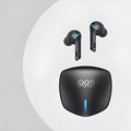 Grey QCY-G1 wireless Bluetooth gaming headset with charging case and ear tips on a table.