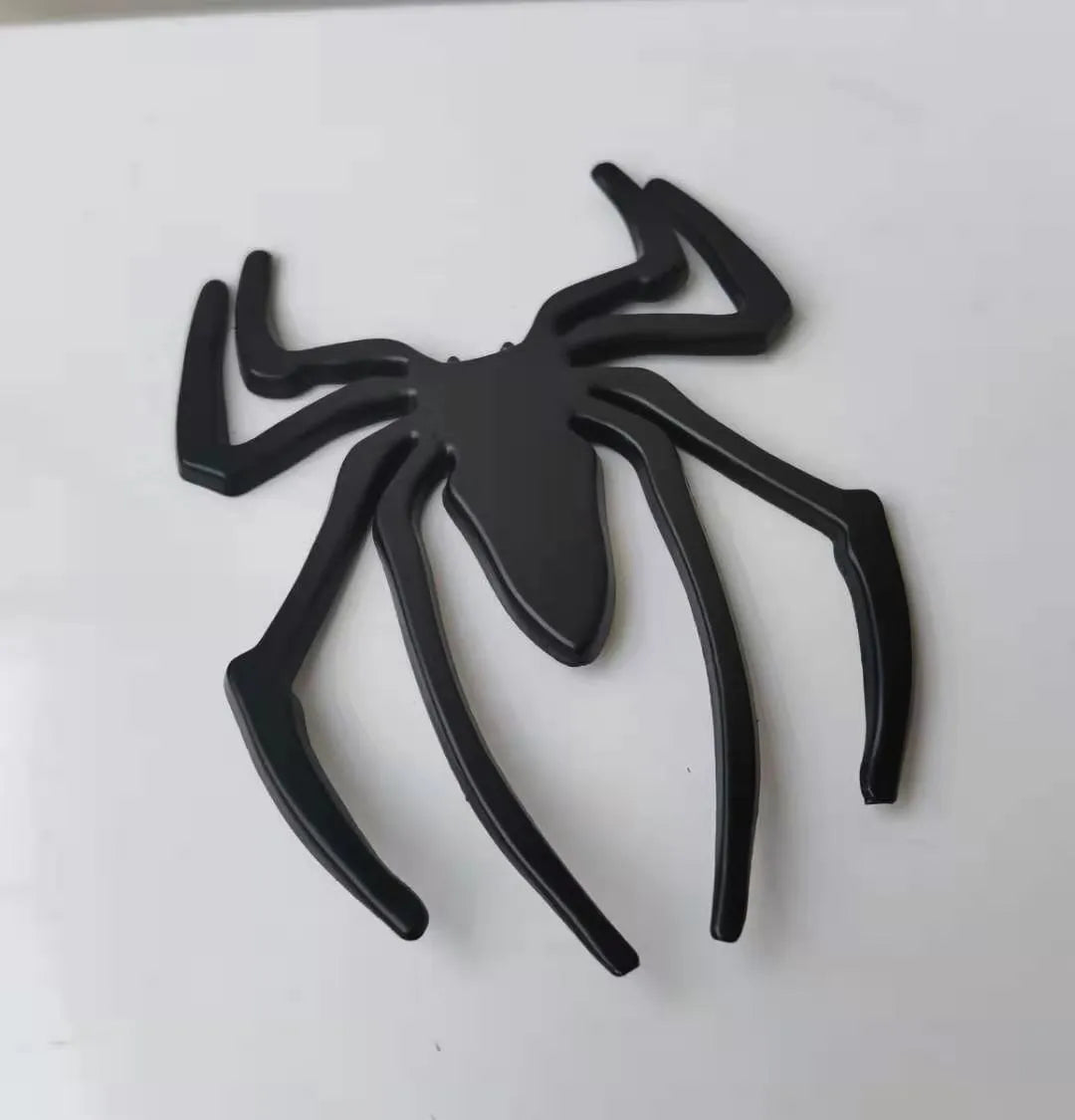 Three-dimensional zinc alloy spider emblem sticker in gold, measuring 7cm by 5cm.