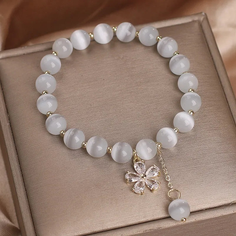 Women's white cat's eye stone bracelet with morganite pendant and flower tassel on safety buckle clasp