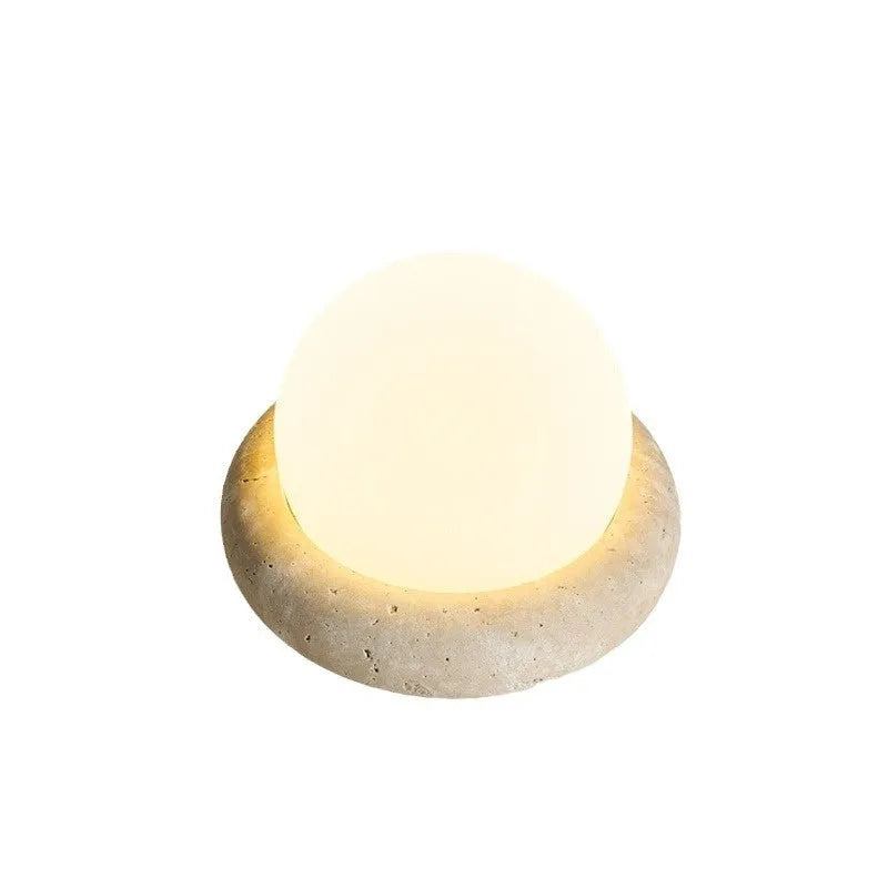 Cream coloured modern bedside night lamp with remote control on wooden table