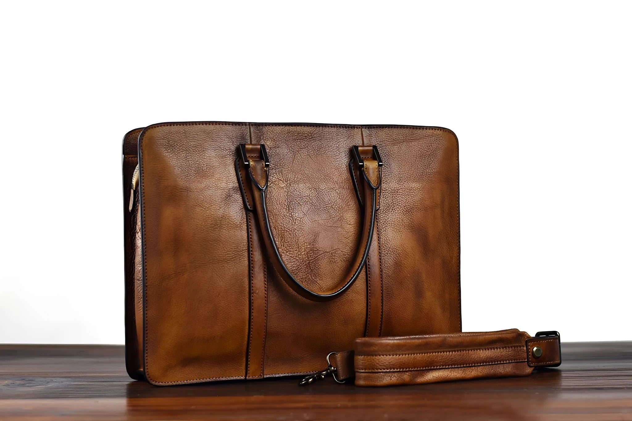 Men's brown leather retro style horizontal handbag with zipper, shown next to a 14-inch laptop for scale.