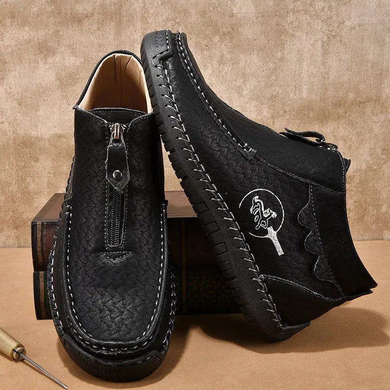 Men's black slip-on leather loafers with round toe and sewn sole detail on a white background.