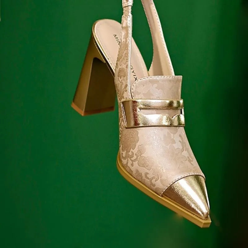 Women's black high heel sandals with chunky heel, pointed toe, and an elastic ankle strap.
